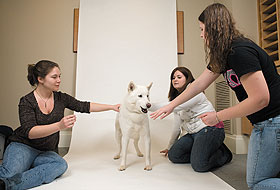Jonathan XIII poses for a portrait, with help from students Julie Jungwirth, left, Kelsey Bahre, center, and Danielle O’Reilly.