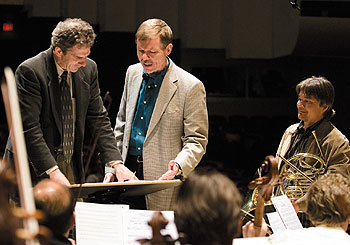 Kenneth Fuchs, a professor of music, center, with Edward Cumming, left, music director of the Hartford Symphony Orchestra, and Richard Todd, principal horn of the Los Angeles Chamber Orchestra, during a rehearsal for the world premiere of Fuchs’ orchestral piece Canticle to the Sun.
