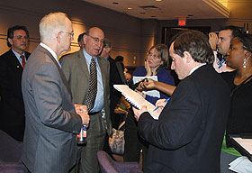 University President Michael J. Hogan, left foreground, and Dr. Myron Genel, vice president of CASE and professor emeritus of Yale University School of Medicine.