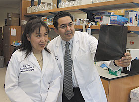 Hicham Drissi, right, director of orthopedic research, with research assistant Amy Tang in a lab at the Health Center’s Musculoskeletal Institute.