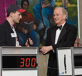 Tom Johnson, a junior, joins President Michael J. Hogan at the UConn Trivia Game Show in the Student Union Friday evening, part of Live @ The U.