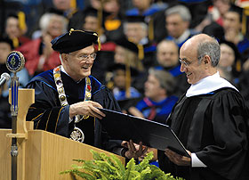 President Hogan hands Gary Gladstein an honorary degree during the Graduate Commencement ceremony held at Gampel Pavilion.