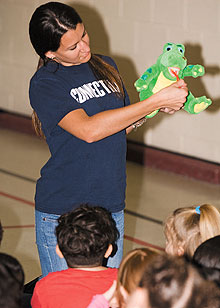 Pamela Karkut, a pre-dental student, demonstrates to children at Natchaug School in Willimantic how to brush their teeth.