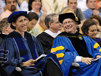 Rebecca Lobo, a member of the Board of Trustees, television commentator and member of the championship 1995 basketball team, shares a laugh with Dr. John W. Rowe, chairman of the Board of Trustees at the College of Liberal Arts and Sciences Commencement ceremony.