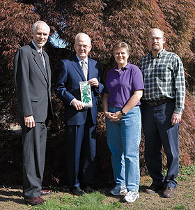 Standing in front of a weeping maple are Gregory J. Anderson, vice provost and dean of the graduate school, President Michael J. Hogan, Virge Kask, designer, and Mark Brand, professor of plant science.