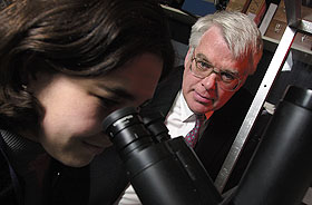 Chemistry professor Robert Birge, in the lab with a graduate student. Birge has a grant to develop an artificial retina.