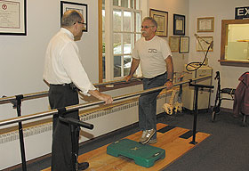 Richard Bohannon, left, professor of physical therapy, works with Sjef van den Berg, emeritus professor of communication sciences, at the Nayden Clinic. Van den Berg was critically injured in a car accident last year.