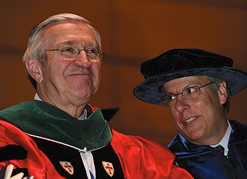 Dr. Peter Deckers, left, executive vice president for health affairs, with Dr. Scott Wetstone, director of health affairs policy planning, during the Health Center Commencement ceremony May 18.