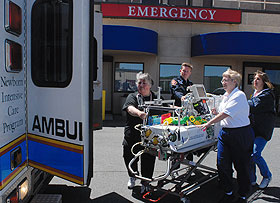 From left, Donna Buchanan and team members Wendell Cote, Mardi Hayden, and Michelle Tardif ready a Health Center neonatal transport van for a call.