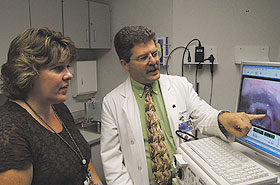 Speech pathologist Janet Rovalino and Dr. Denis Lafreniere of the Health Center’s Voice and Speech Clinic, review a video image of a patient’s vocal cords.