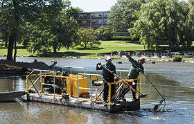 Workers from All Habitat Inc. clean the bottom of Mirror Lake.