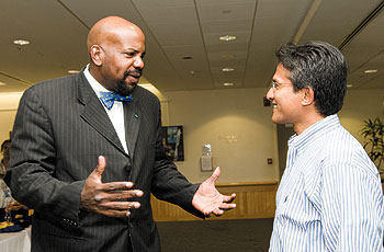 Dr. Cato T. Laurencin, left, who joined the Health Center as vice president for health affairs and dean of the School of Medicine in August, speaks with Timorty Hia, director of the Center for Vascular Biiology, during a reception Aug. 20.