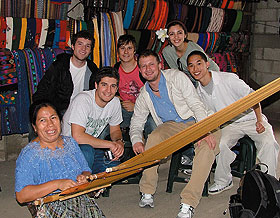 Students in the social entrepreneurship Study Abroad program in Guatemala pose with a weaver. 