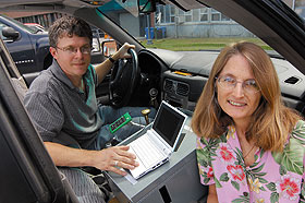 Research associate John Cooley and Christine Simon, professor of ecology and evolutionary biology, with a Global Positioning System that Cooley and his brother assembled to track periodical cicadas.