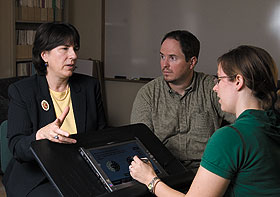 Patricia Neafsey, left, professor of nursing, discusses the medication management software she developed with honors students Gregory Lutkus and Jessica Newcomb. 