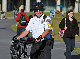 Sgt. Christopher Casa, a community police officer, with his bike at the Student Union Mall.