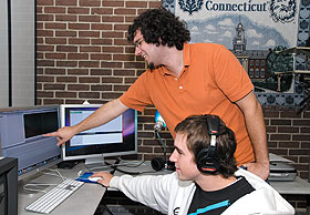 Nick Sieckowski, seated, a sophomore, and Greg Santone, a junior, use one of the new multimedia studios in the Homer Babbidge Library.