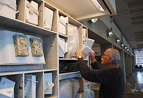Werner Pfeiffer assembles his installation ‘Endangered Species’ in the Bookworms Café in Homer Babbidge Library.
