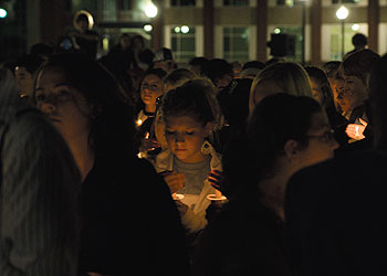 Students holding candles observe a moment of silence during a rally to promote awareness and prevention of sexual assault. The rally was held outside the Student Union on October 15.