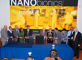 Legislators and other dignitaries join University President Michael Hogan, center, and Gov. M. Jodi Rell, fifth from right, for a ribbon-cutting at the nanobionics ‘clean room’ on Oct. 20. 
