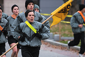 Lt. Col. Christine Harvey, center, head of the military science department, leads a group of Army ROTC cadets on a morning run.