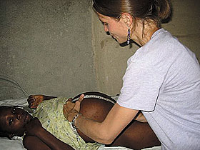 Cheryl Bilinski, an MD/MPH student, examines a patient at a clinic for pregnant women in Haiti, where she spent the summer. 