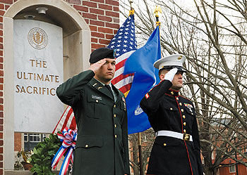 UConn students Dymitri Dutkanicz, left, a U.S. Army veteran, and Dimitry Nussberg, a Marine Corps veteran, salute in front of the new memorial during the Veterans Day ceremony on Nov. 10.