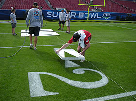 Kyle Carney, a student in the turfgrass program, assists the grounds crew preparing for the Superbowl at Raymond James Stadium in Tampa, Florida.