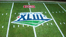 Kyle Carney used a hand-drawn stencil to create a painted Super Bowl XLIII logo on a mini NFL field he set up on his parents' lawn as part of his scholarship application.