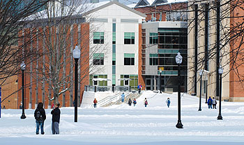A winter view of students walking across the Student Union Mall near the Gentry Building.