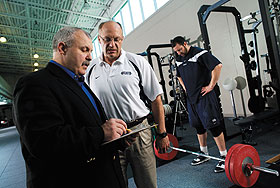 William Kraemer, professor of kinesiology, left, and Gerard Martin, strength and conditioning coach, meet in the strength and conditioning facility at The Burton Family Football Complex and Mark R. Shenkman Training Center.