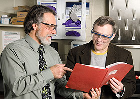 Stefan Wawzyniecki (left), manager of environmental health and safety, and Steven Suib, department head and distinguished professor of chemistry, examine safety protocol in a teaching lab in the Chemistry building.