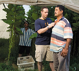 Homero Gonzalez, right, a migrant worker, has his heart checked by Christopher Binette, a 2008 graduate of the School of Medicine, as Felipe Martinez waits his turn.