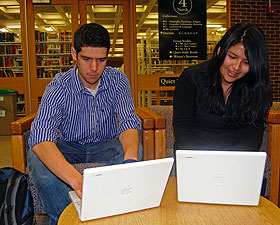 Zachary Colombo, a sophomore, and Sabrina Jara, a senior, examine the new laptops on Level 4 of Babbidge Library. The iBooks will soon be available for loan.