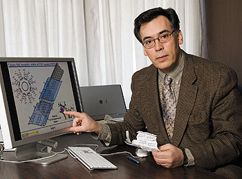 Fotios Papadimitrakopoulos, professor of chemistry, with a diagram illustrating part of his research on carbon nanotubes.