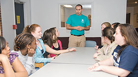 Miguel Colon, a program coordinator in Student Activities, leads a meeting of students in the Community Service living-learning community in Ellsworth residence hall. 