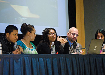Jason Irizarry, second from right, an assistant professor of curriculum and instruction, listens as students from Windham High School discuss Project Fuerte, a research initiative in which the students learn about structural inequalities in education. The students gave a presentation in the Student Union Theatre on March 26.