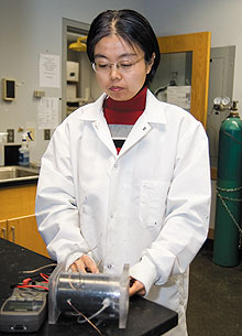 Baikun Li, assistant professor of civil and environmental engineering, tests the voltage of a microbial fuel cell.