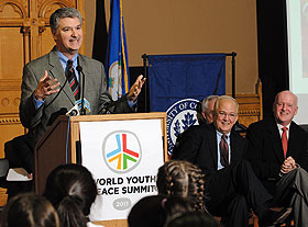 Senate President Donald Williams speaks at a press conference in the Old Judiciary Room at the State Capitol. Seated are President Michael Hogan and Dan Doyle, founder of World Youth Peace Summit.