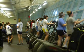 Image: Students work out on exercise machines.