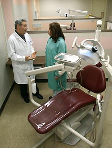 Image: Dr. Joseph Grasso and Jessie Ortiz with new dental chair.
