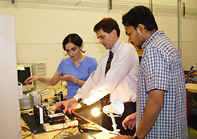 Image: Niloufar Fekerarad, Ray England and Navin Viswanathan look over a fuel cell experiment.