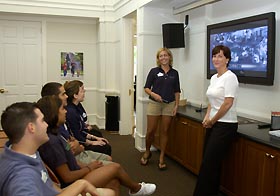 Image: Meg Malmborg and Christian Geslien discuss campus tours with student tour guides.