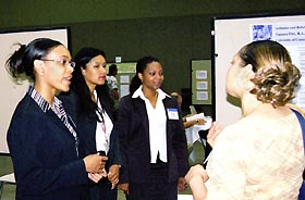 Image: Students discuss their poster presentation.